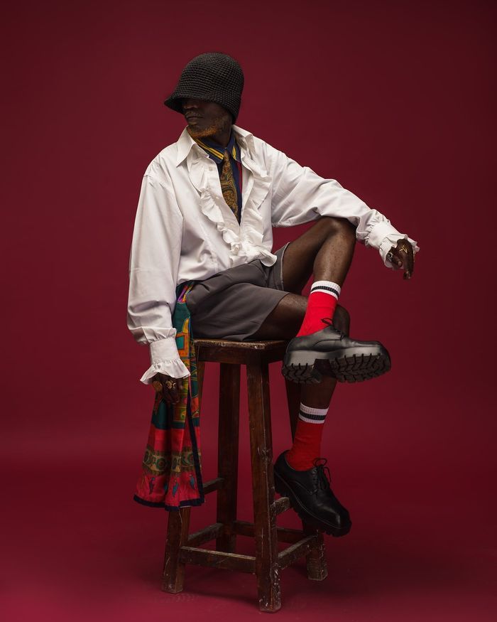 Studio fashion editorial on a red backdrop